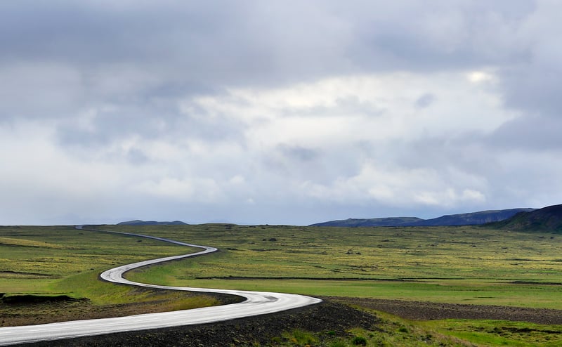 Silhouette of a person on a road, symbolizing a journey